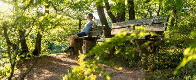 Wanderin ruht sich auf einer Bank aus