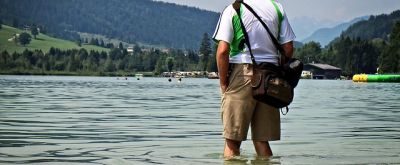 Mann im Wasser Mann mit kurzen Hosen steht im Wasser