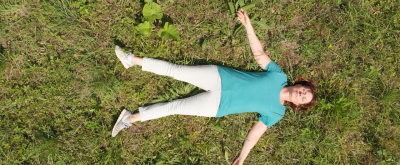 Yoga in der Natur Yogalehrerin liegt entspannt auf einer Lichtung im Wald