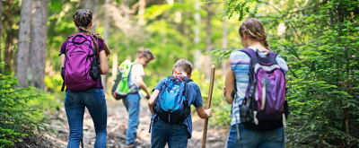 Kinder mit Wanderrucksäcken im Wald